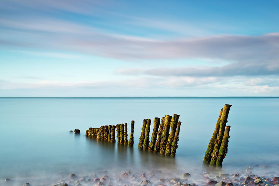 Wooden Groynes On A Beach At Low Tide Photograph by Jeremy Walker