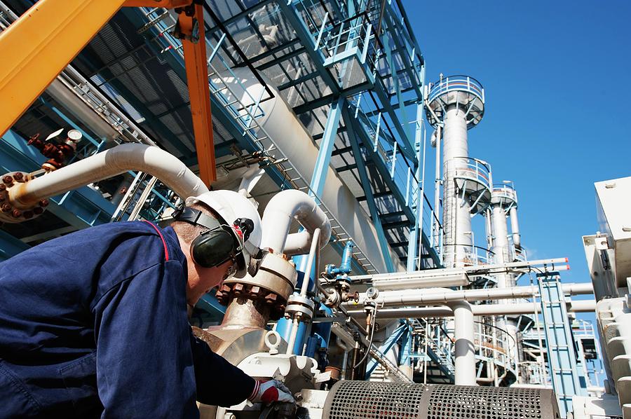 Worker Checking Pipework On An Oil And Gas Refinery Photograph by Christian Lagerek/science Photo Library
