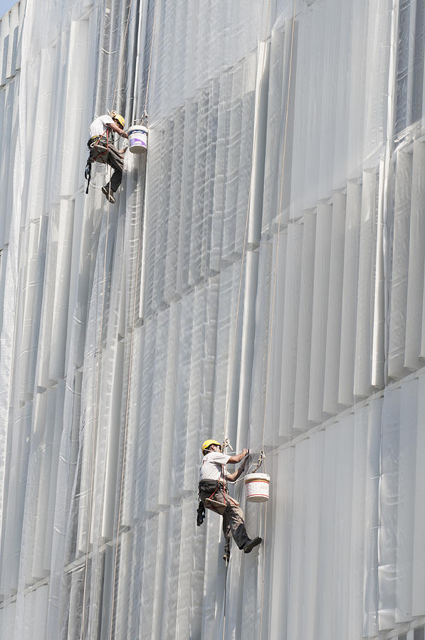 Workers on facade of building Photograph by Matthias Hauser
