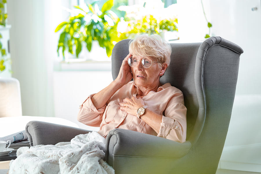 Worried elderly lady having pain in chest Photograph by Izusek