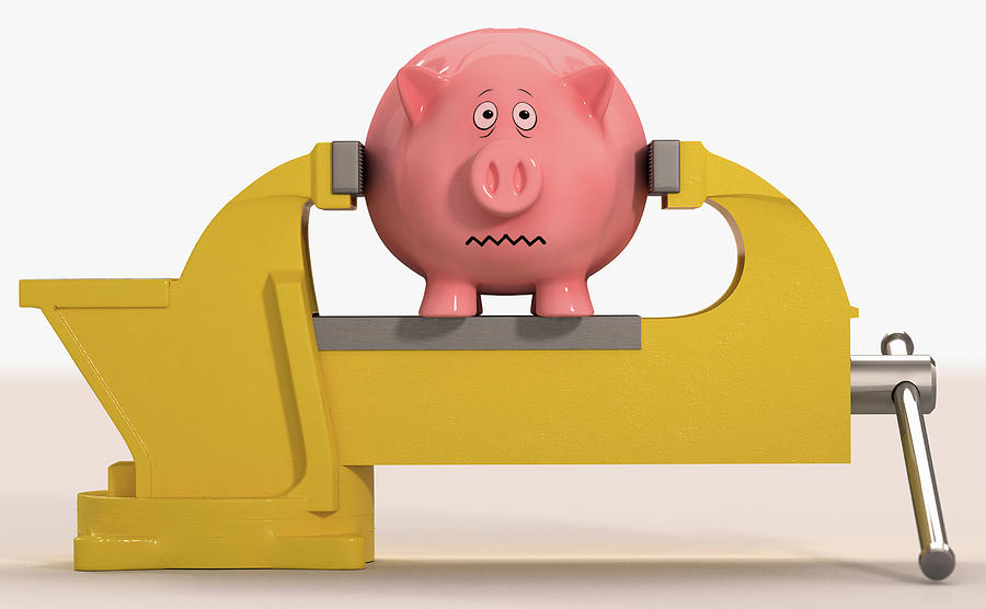 Worried Piggy Bank Being Squeezed Photograph by Ikon Images