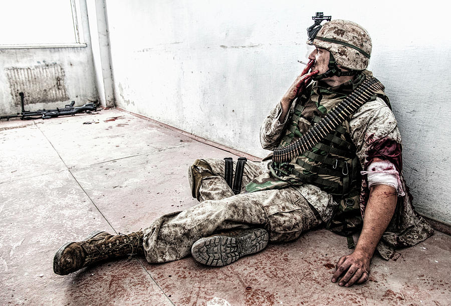 Wounded Solider Sitting On Floor Photograph by Oleg Zabielin