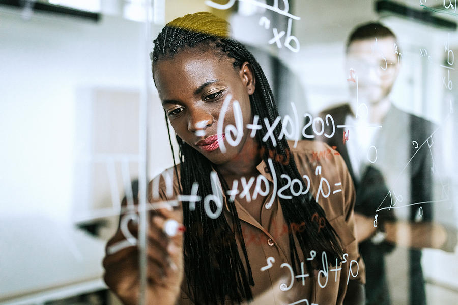 Writing Mathematical Formulas On Transparent Wipe Board Photograph by Pekic