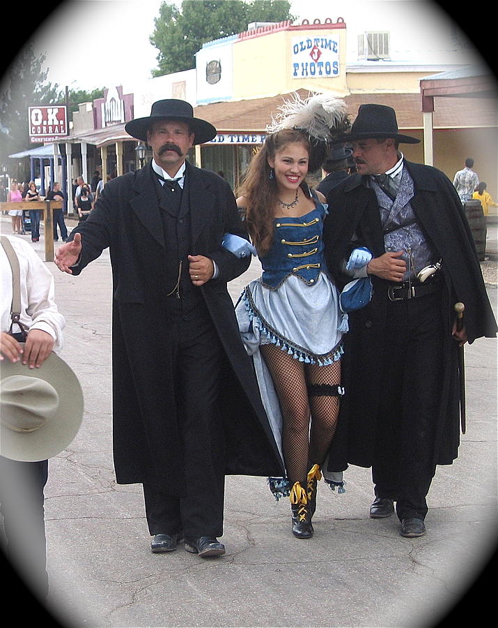 Wyatt Earp  Doc Holliday escort  woman  with O.K. Corral in  background 2004 Photograph by David Lee Guss
