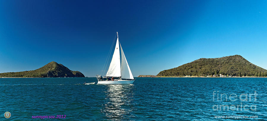 Yacht sailing past Yacaaba and Tomaree Heads  Port stephens.      Photograph by Geoff Childs