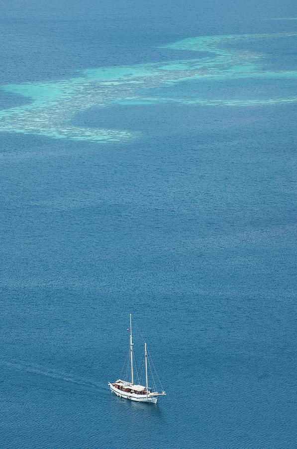 Yacht With Coral Reef Behind Photograph by Scubazoo