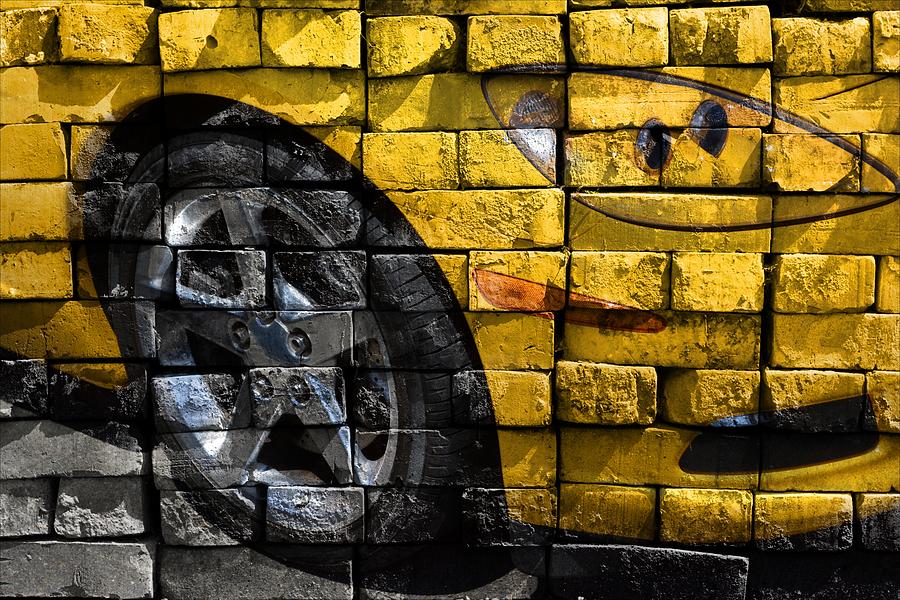 Yellow bricks and a tire Photograph by Ricardo Dominguez