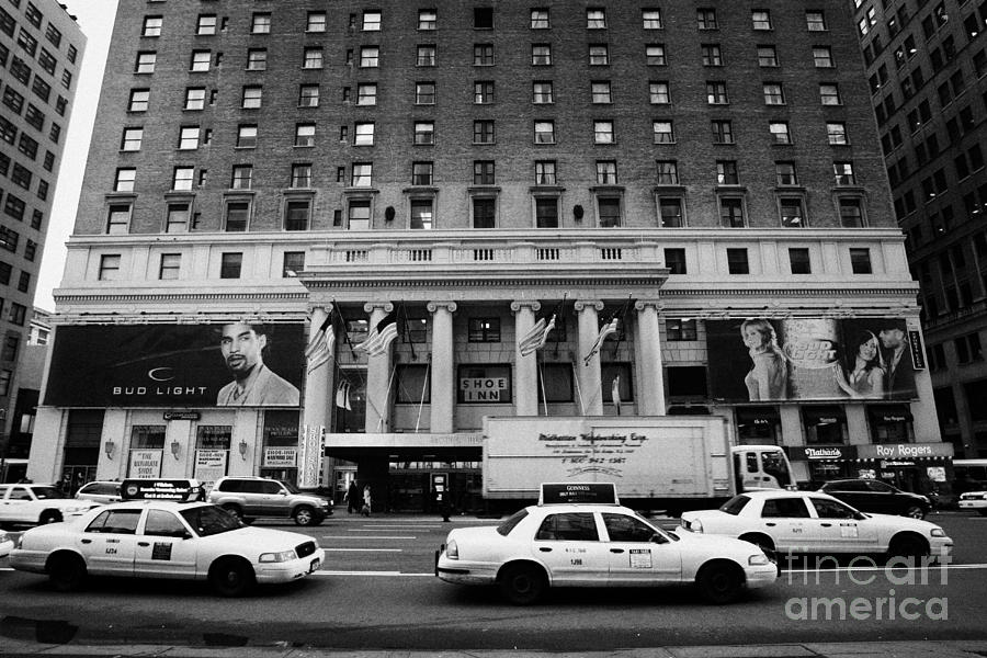 Winter Photograph - Yellow Cabs Go Past Pennsylvania Hotel On 7th Avenue New York City Usa by Joe Fox