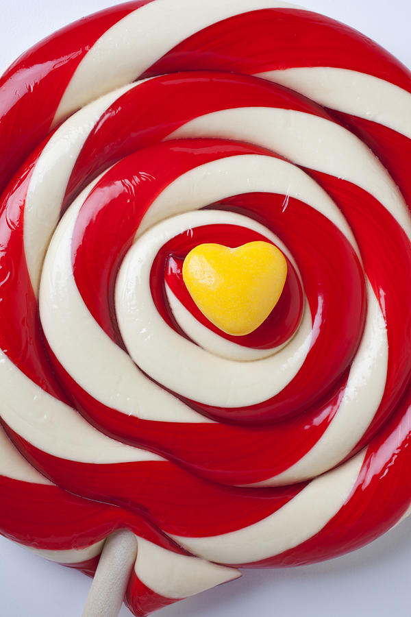 Candy Photograph - Yellow candy heart on sucker by Garry Gay