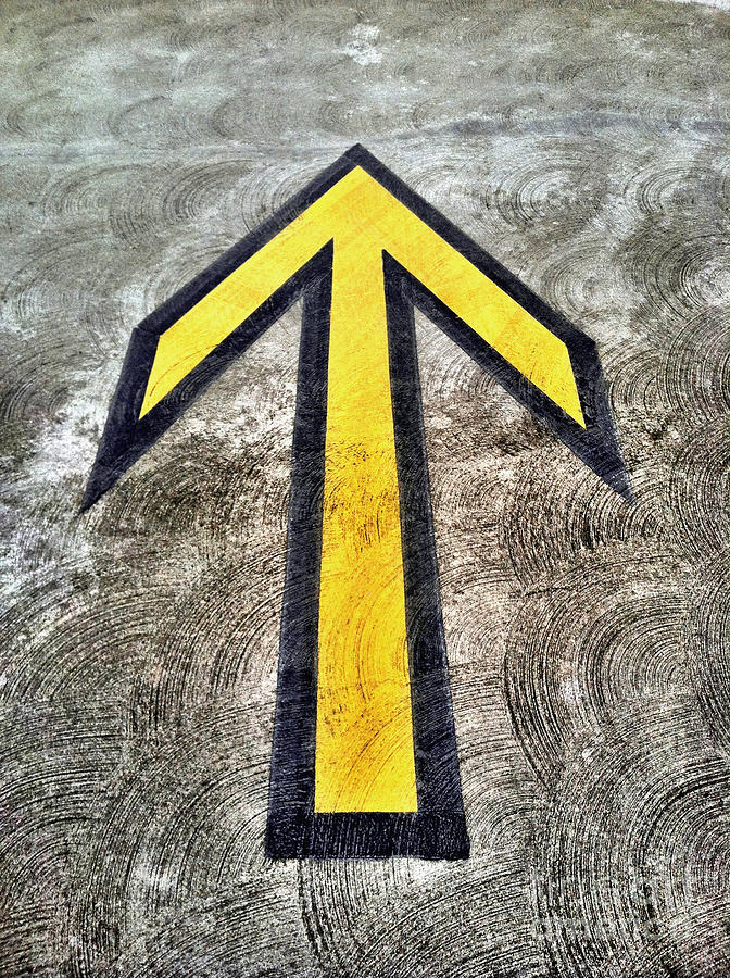 Yellow directional arrow on pavement Photograph by Bryan Mullennix