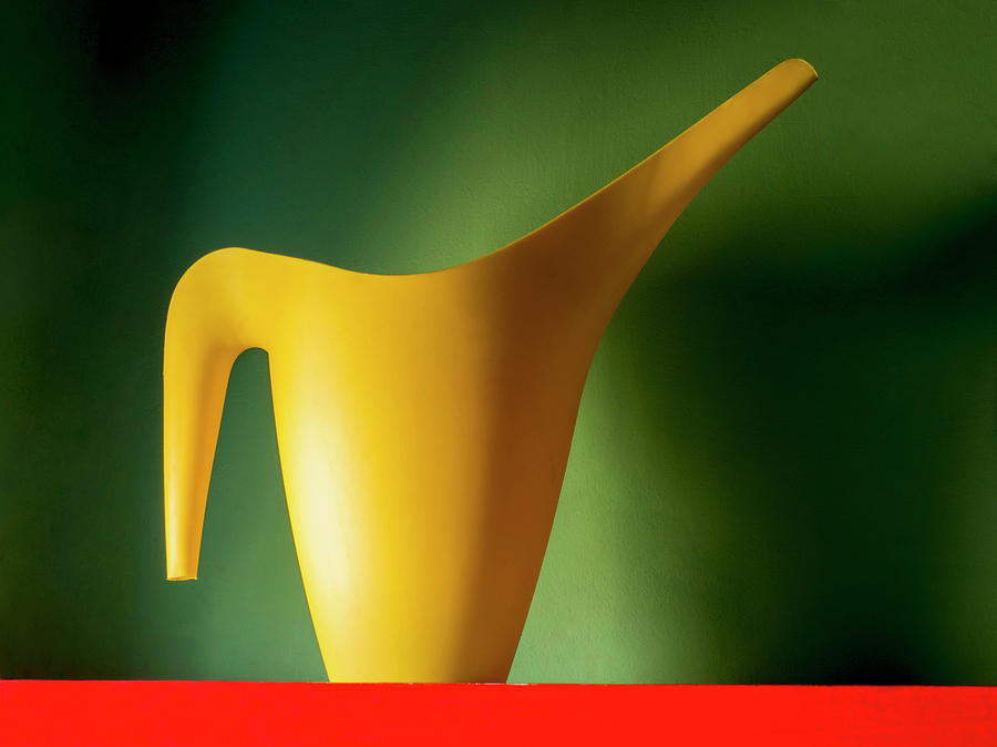 Yellow Jug On A Red Surface Photograph by Charles Bowman