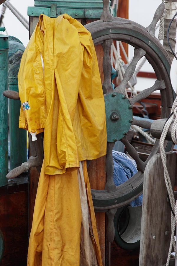Yellow rain wear on a ship Photograph by Ulrich Kunst And Bettina Scheidulin