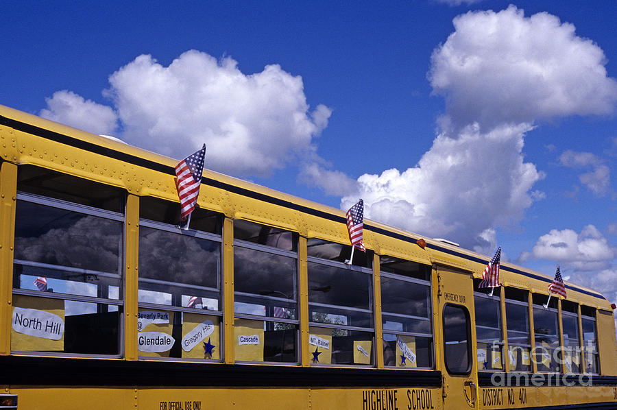 Yellow school bus with American Flags Photograph by Jim Corwin