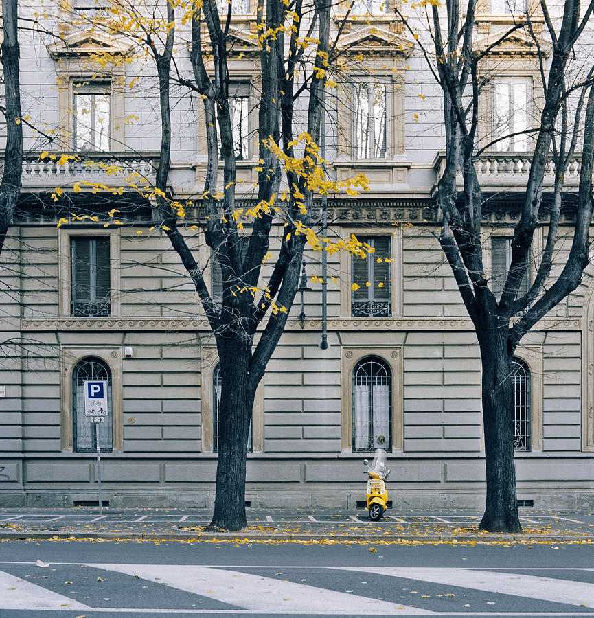 Yellow scooter parked in Milan, Italy Photograph by Marcoventuriniautieri