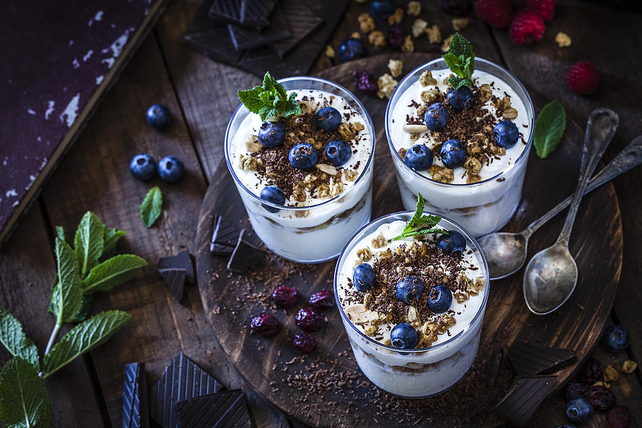 Yogurt with granola, berry fruits and chocolate Photograph by Fcafotodigital