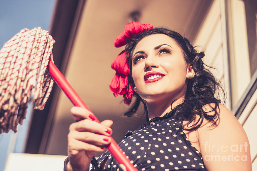 Young 50s brunette housewife holding red mop Photograph by Jorgo Photography