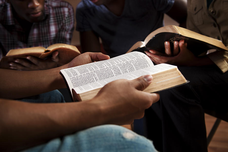 Young adults in a Bible study. Photograph by Fstop123