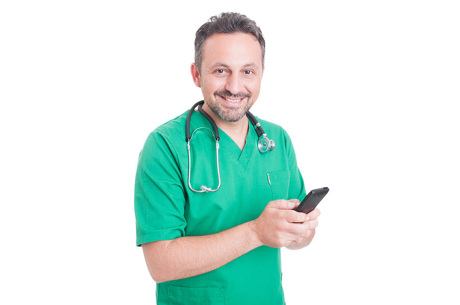 Young and modern doctor using smartphone Photograph by Catalin205