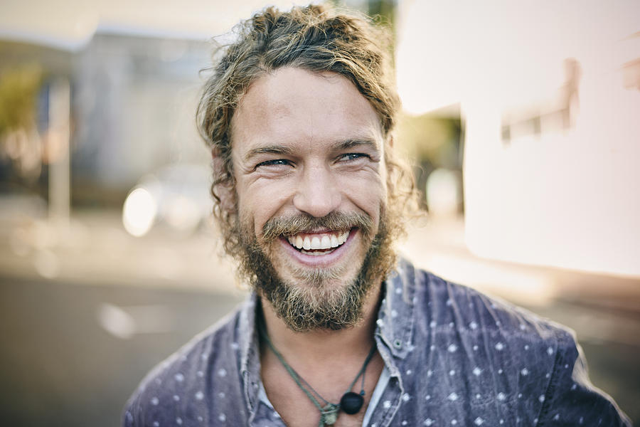 Young bearded man smiling Photograph by Uwe Krejci