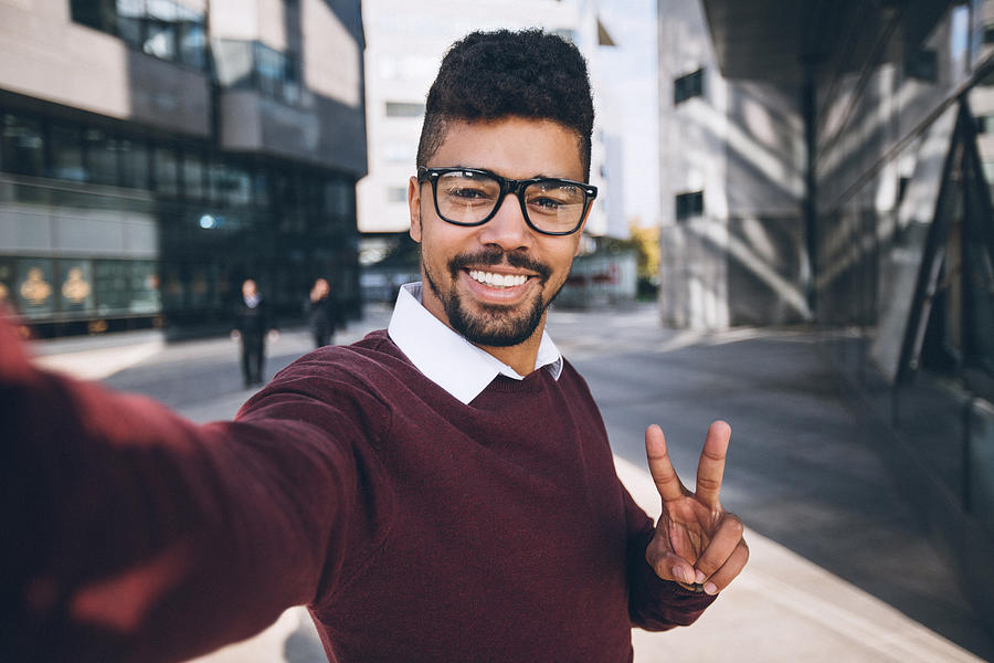 Young black business man taking funny selfie Photograph by Pekic