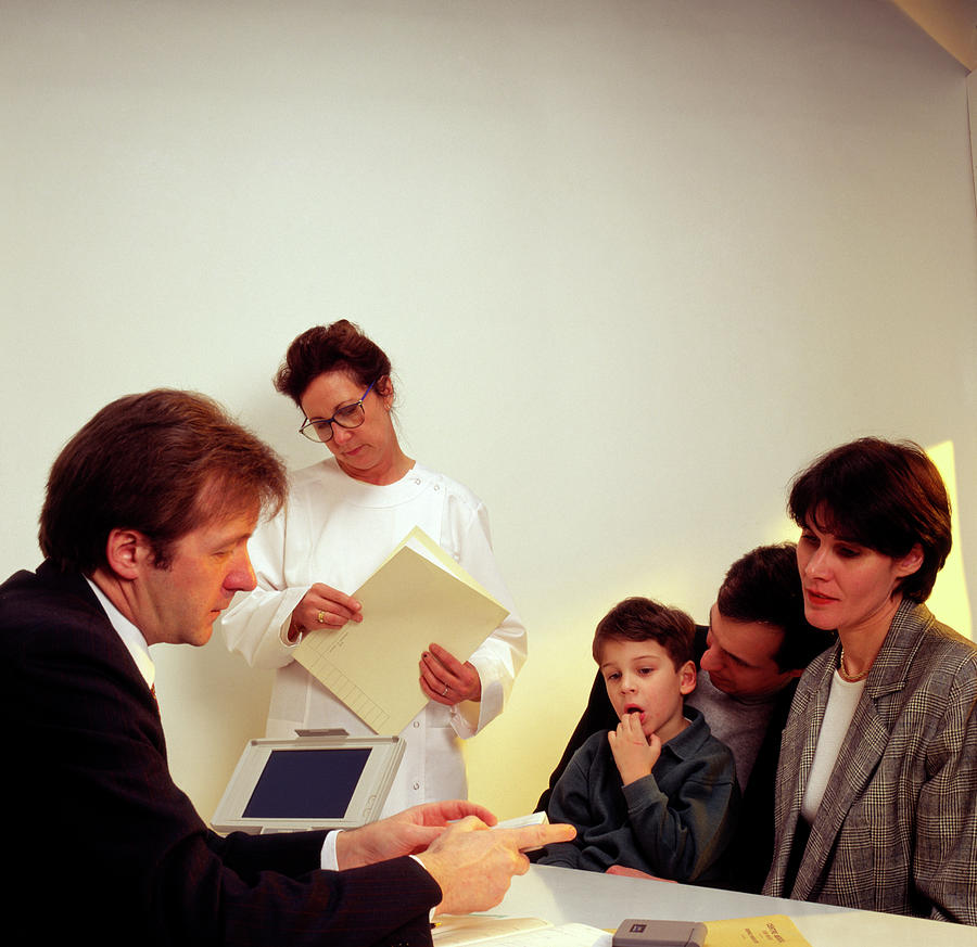 Young Boy & Parents In Consultation With Gp Doctor Photograph By Cc ...