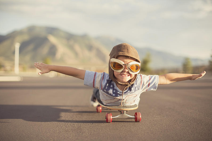 Young Boy Imagines Flying On Skateboard Photograph by RichVintage