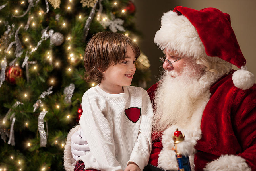 Young Boy in Awe Sits on Santas Lap Photograph by Avid_creative