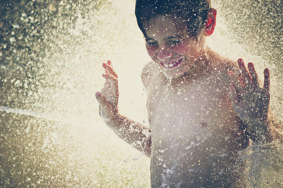 Young Boy In Splashing Water Backlit By Photograph by Fran Polito
