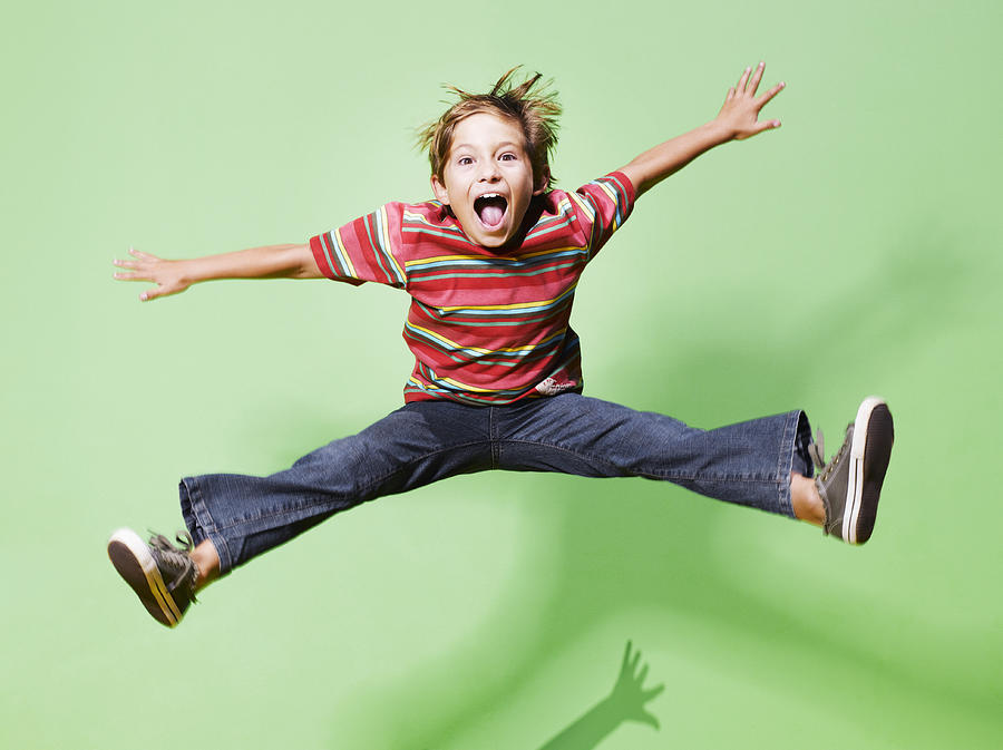 Young boy jumping in mid-air Photograph by Robert Daly