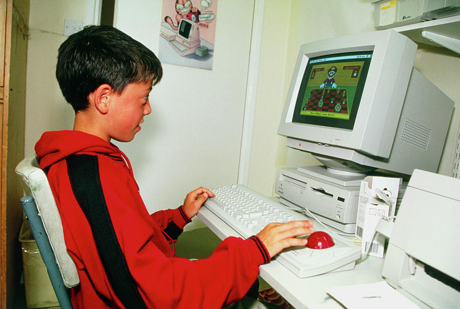 Young Boy Playing On A Personal Computer Photograph by Antonia Reeve/science Photo Library