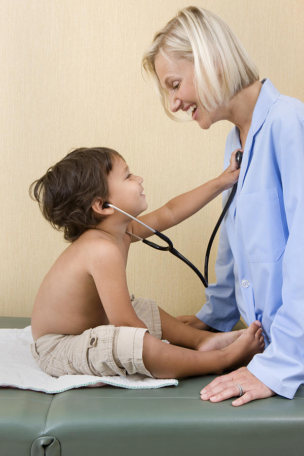Young boy plays with doctors stethoscope. Photograph by Katrina Wittkamp