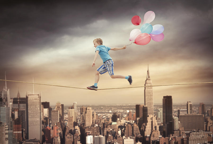 Young boy running with balloons on the rope Photograph by Narvikk