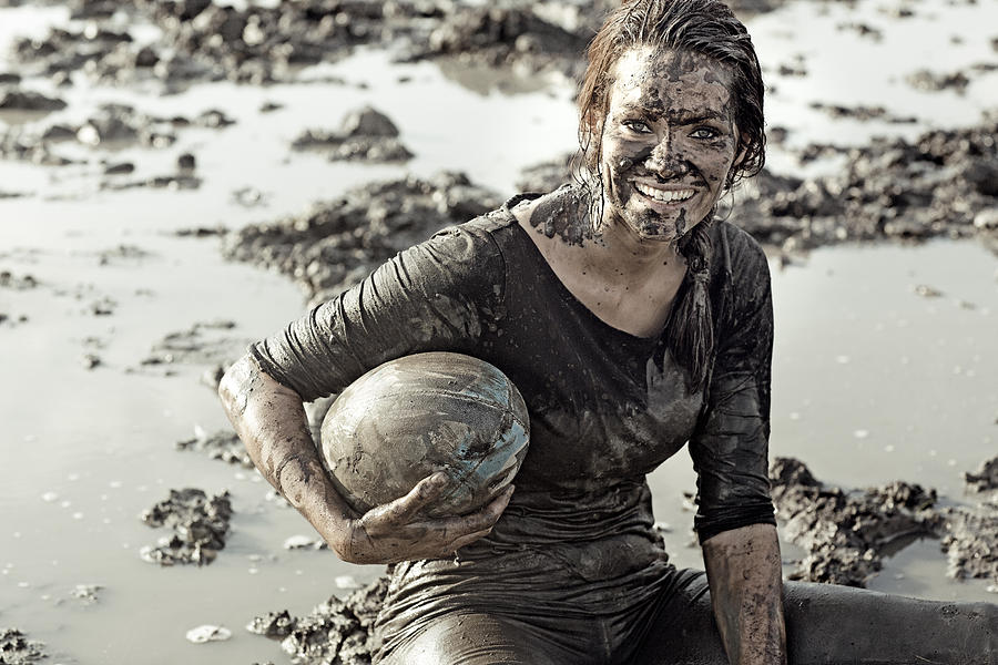 Young brunette female smiling during a mud run Photograph by Lorado