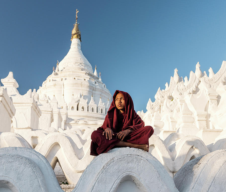 Young Buddhist Monk Sitting On Temple Photograph by Martin Puddy