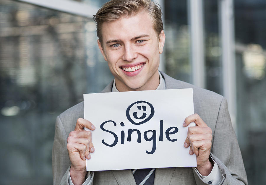 Young business man holding single sign Photograph by Dimitri Otis
