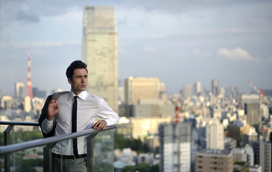 Young businessman at Tokyos background Photograph by Vladimir Zakharov