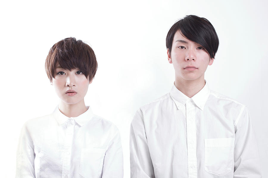 Young couple standing to look straightforward Photograph by Tadamasa Taniguchi