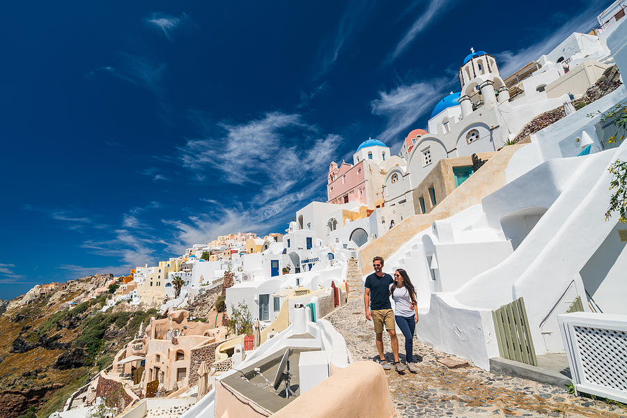 Young Couple Walking In Oia Santorini Photograph by Amriphoto