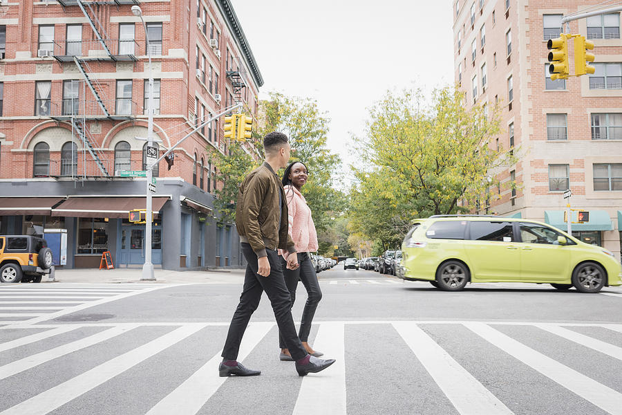 Young couple walking in the city Photograph by Tony Anderson