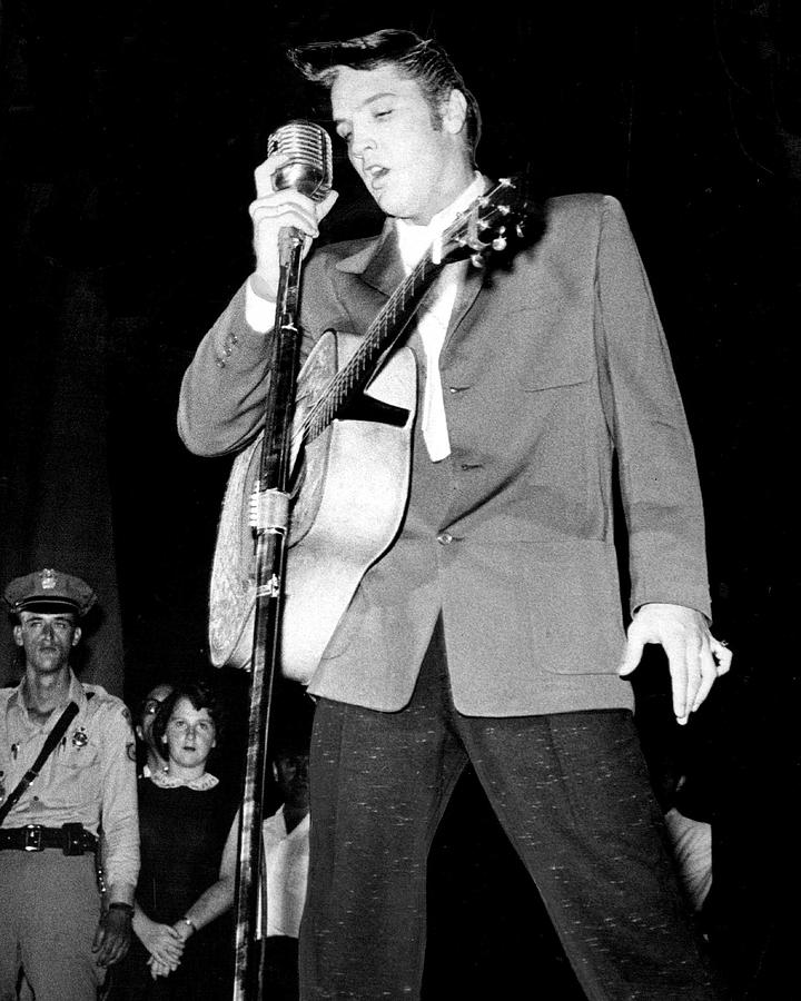 Elvis Presley Photograph - Young Elvis Presley Stands Over Microphone by Retro Images Archive