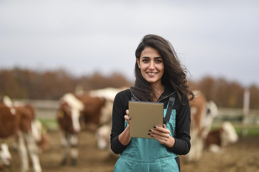 Young female farmer using a digital tablet Photograph by Baranozdemir