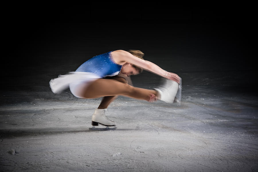 Young female figure skater performing Photograph by Simonkr