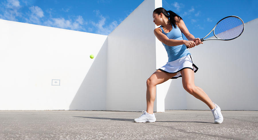 Young Female Hitting Tennis Ball Against A Wall Photograph by Nycshooter