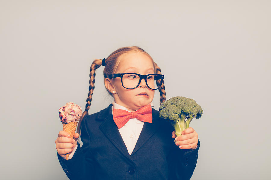 Young Female Nerd Holds Ice Cream and Broccoli Photograph by RichVintage