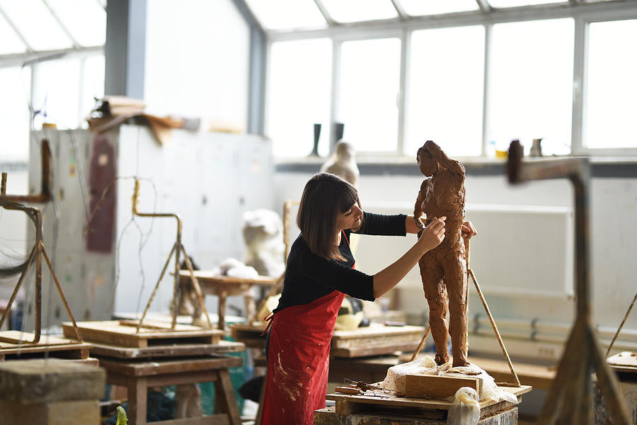 Young Female Sculptor is working in her studio Photograph by Baranozdemir