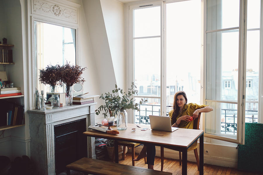 Young freelancer woman relaxing in her Parisian apartment Photograph by Lechatnoir