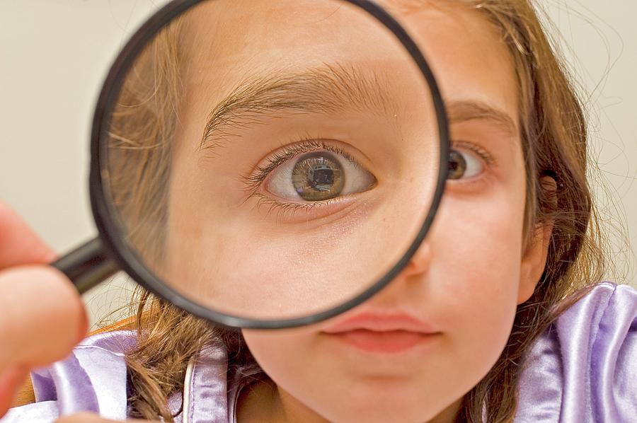 Young Girl And Magnifying Glass Photograph by Photostock-israel/science Photo Library