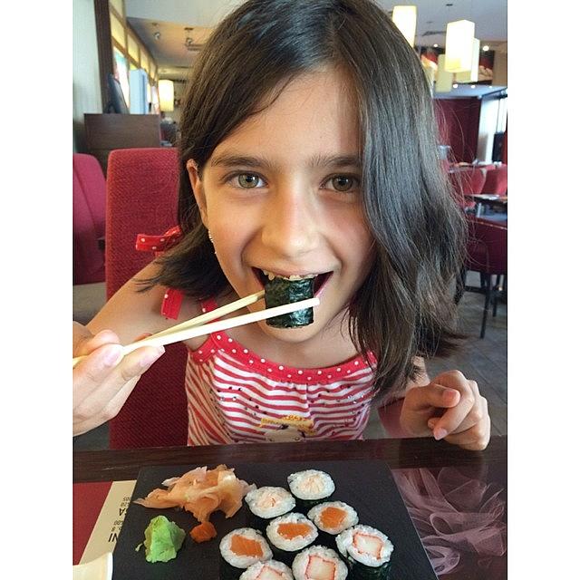 Sticks Photograph - Young Girl Eating Sushi In A Japanese by Adriano La Naia