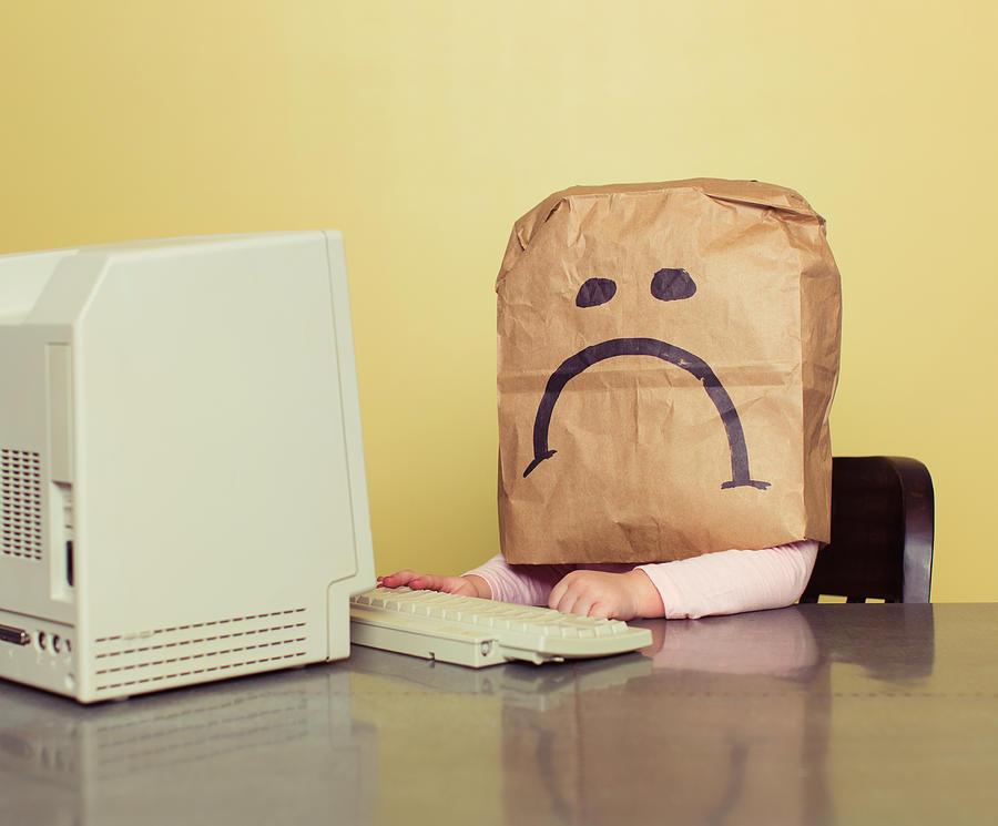 Young Girl in Front of Computer with Brown Bag Frown Photograph by RichVintage