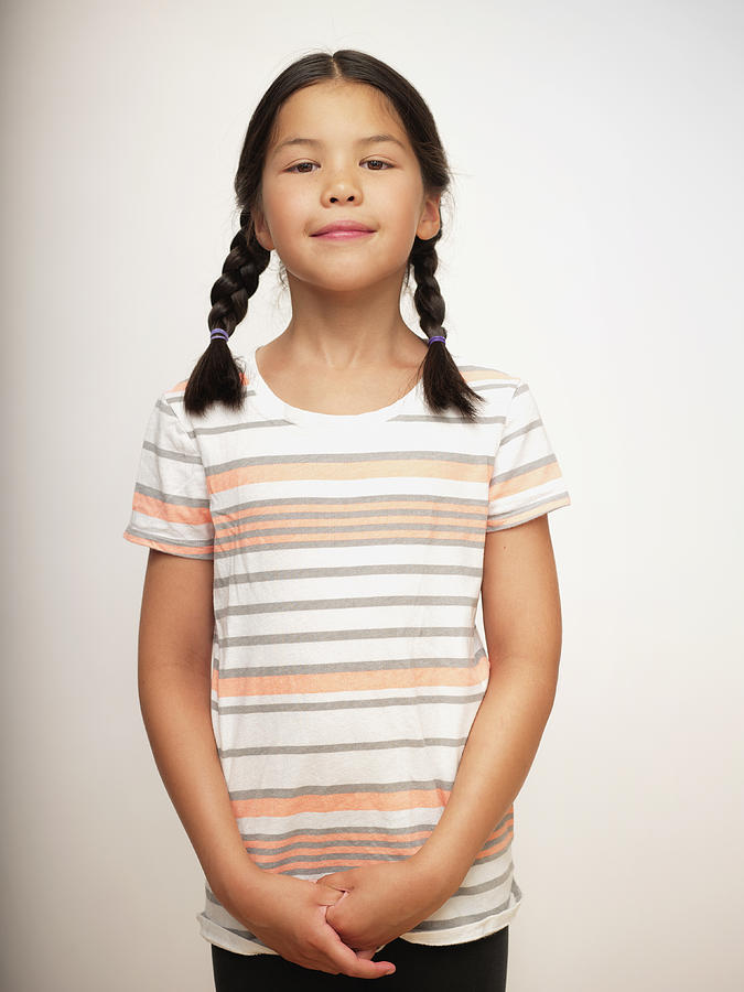 Young girl in striped shirt and braids, portrait Photograph by Ron Levine
